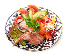 Meat on a grill with vegetables