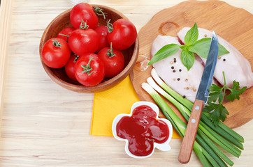 Raw chicken breasts on cutting board