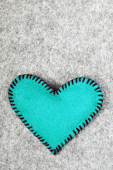 blue felt heart on a gray background