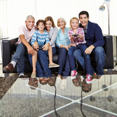 Familie schaut Kindern beim Videospielen zu