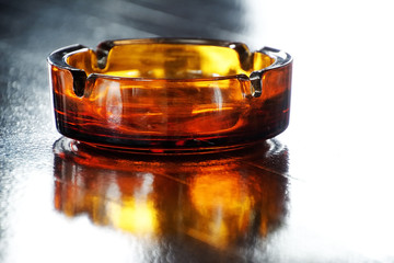 Glass ashtray on wooden table
