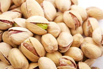 Heap of pistachios nuts isolated on the white