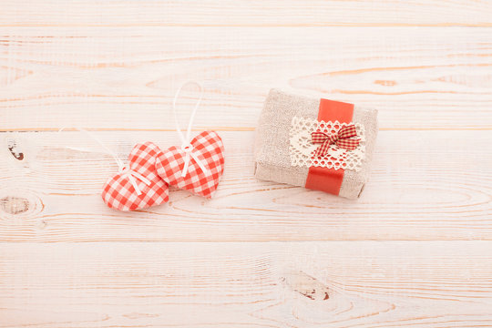 Hearts and gift on wooden background. Valentines day. Beautiful.