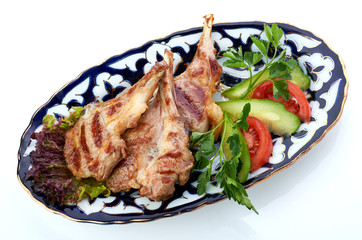 Meat on a grill with vegetables