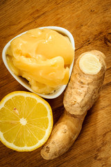 ginger root, honey and lemon on wooden rustic table.