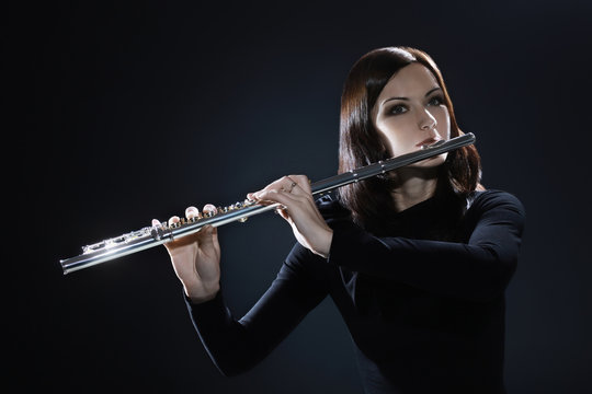 Flutist playing flute music instrument