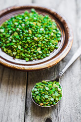 Organic split peas on wooden background