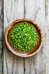 Fototapeta na wymiar Organic split peas on wooden background