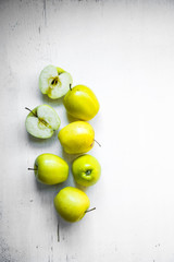 Bright apples on white wooden background