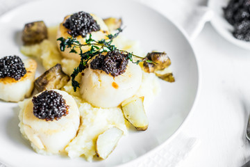 Scallops with black caviar