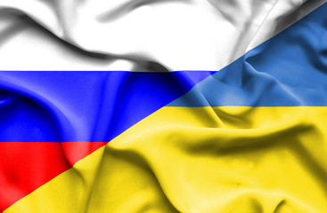 Fototapeta premium Waving flag of Ukraine and Russia