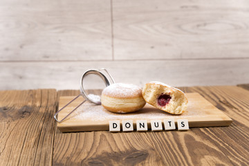 Jummy donuts on wooden table