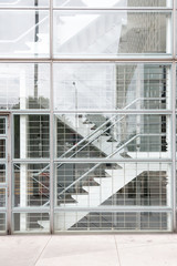 Interior of a modern glass building with stairs.