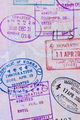 Asian passport page with various exit and entry stamps