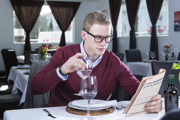 businessman reading at a restaurant .