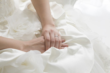 Bride sitting wearing a wedding dress