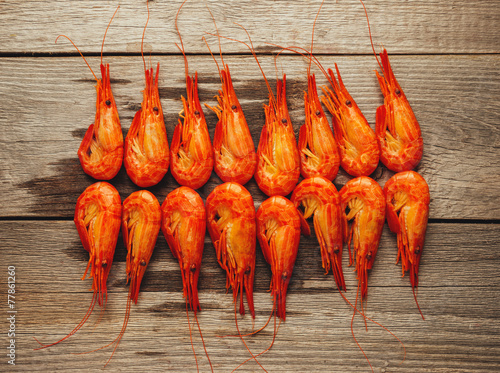 Boiled shrimps on wooden background