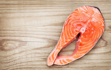 Piece of salmon on wooden background