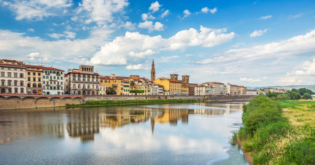 Fototapeta na wymiar View of Ponte Vecchio with reflections in Arno River, Florence,