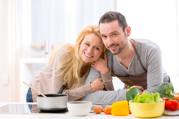 Young attractive couple cooking in a kitchen