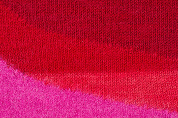Knit woolen texture. Red woven thread sweater as a background.