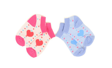 Tow pairs of girl and boy socks with hearts isolated on white.