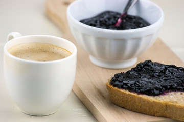 Homemade blueberry jam with integral bread and coffe