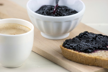 Homemade blueberry jam with integral bread and coffe
