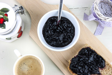 Homemade blueberry jam with integral bread and coffe