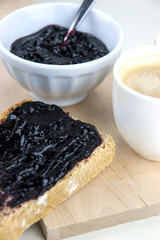 Homemade blueberry jam with integral bread and coffe