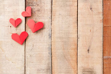 Origami hearts on wooden background with copy-space