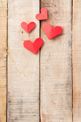 Origami hearts on wooden background with copy-space