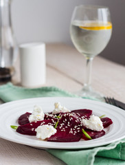 roasted beet salad with goat cheese, olive oil and sesame seeds