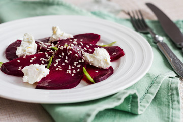 roasted beet salad with goat cheese, olive oil and sesame seeds