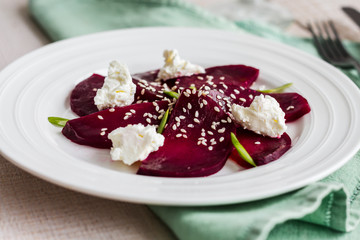 roasted beet salad with goat cheese, olive oil and sesame seeds