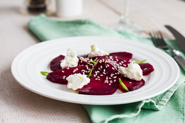 roasted beet salad with goat cheese, olive oil and sesame seeds