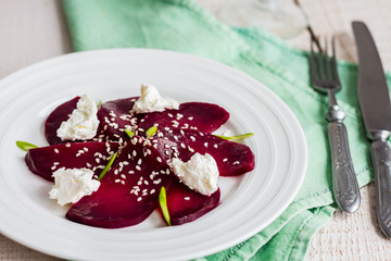 roasted beet salad with goat cheese, olive oil and sesame seeds