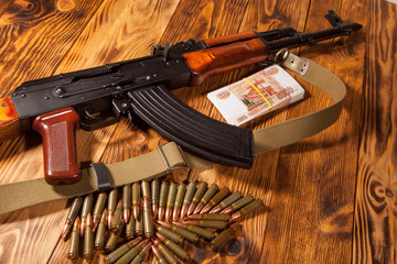 Kalashnikov rifle and Russian rubles