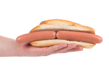 Hand holds hotdog with two sausages.