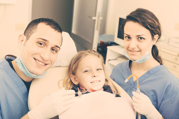 Dentist and Dental Assistant Portrait with Young Patient.