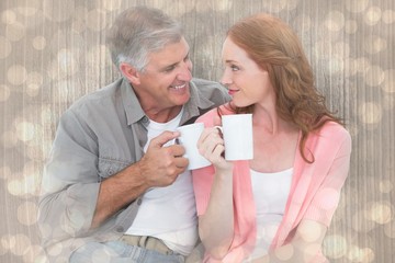 Obraz na płótnie Canvas Composite image of casual couple having coffee together