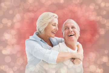 Composite image of happy mature couple smiling at each other
