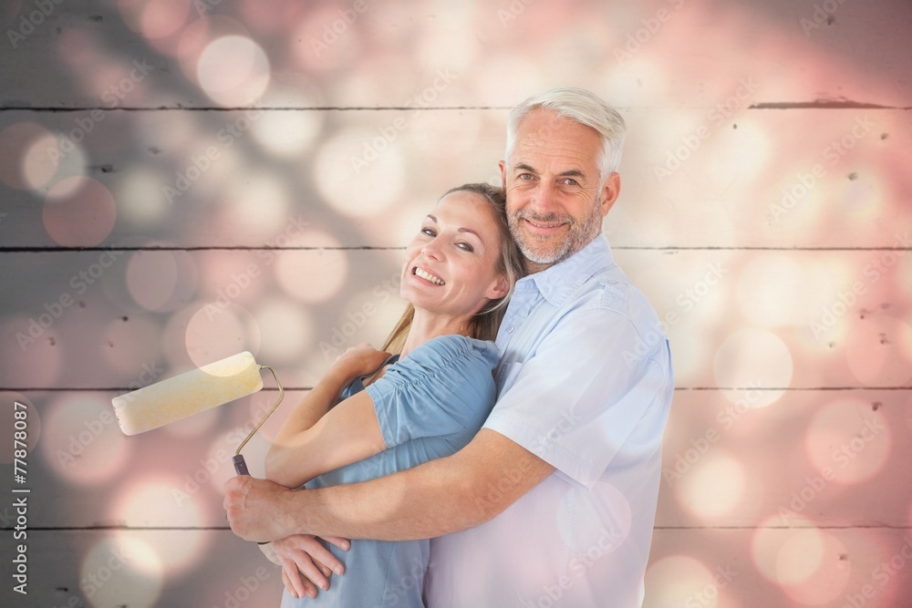 Poster composite image of happy couple hugging and holding paint roller