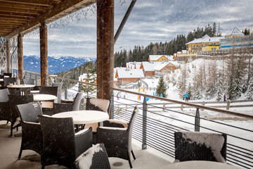 terrace covered by snow at ski resort restaurant