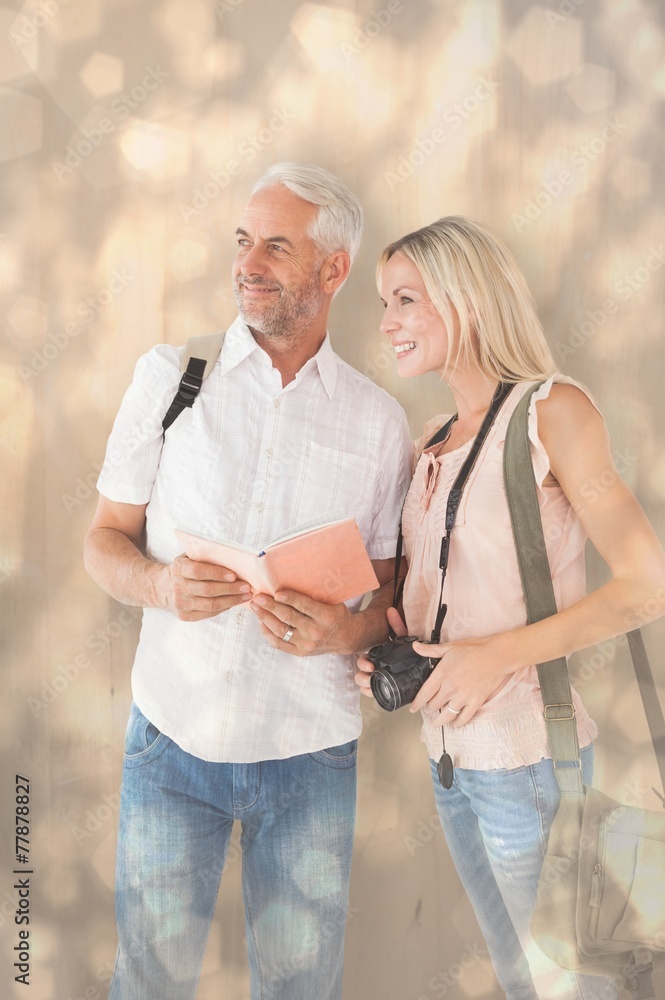 Aufkleber composite image of happy tourist couple using the guidebook