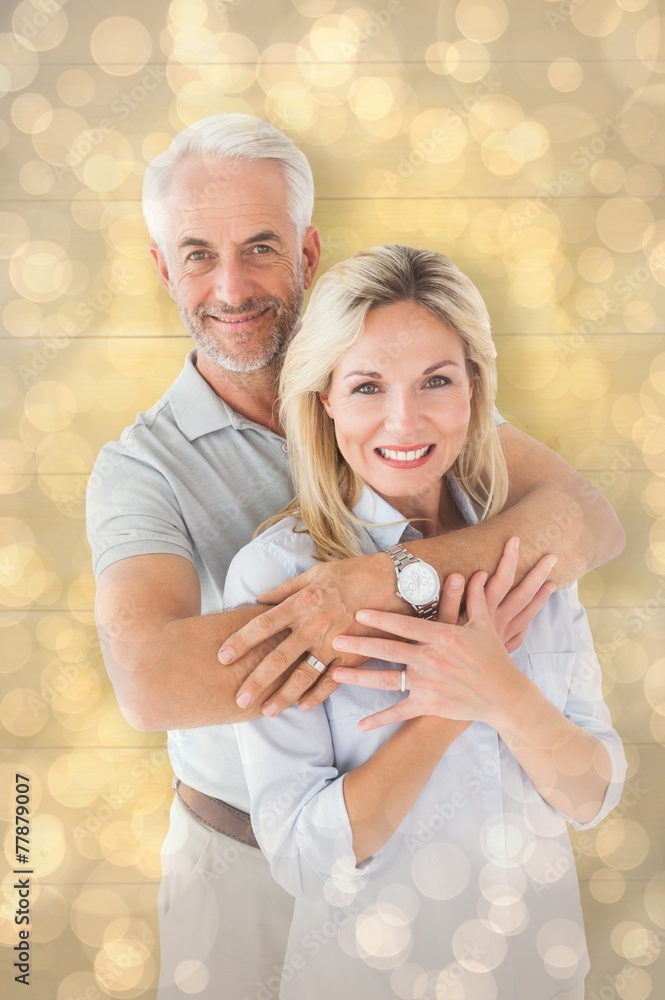 Poster Composite image of happy couple smiling at camera and embracing