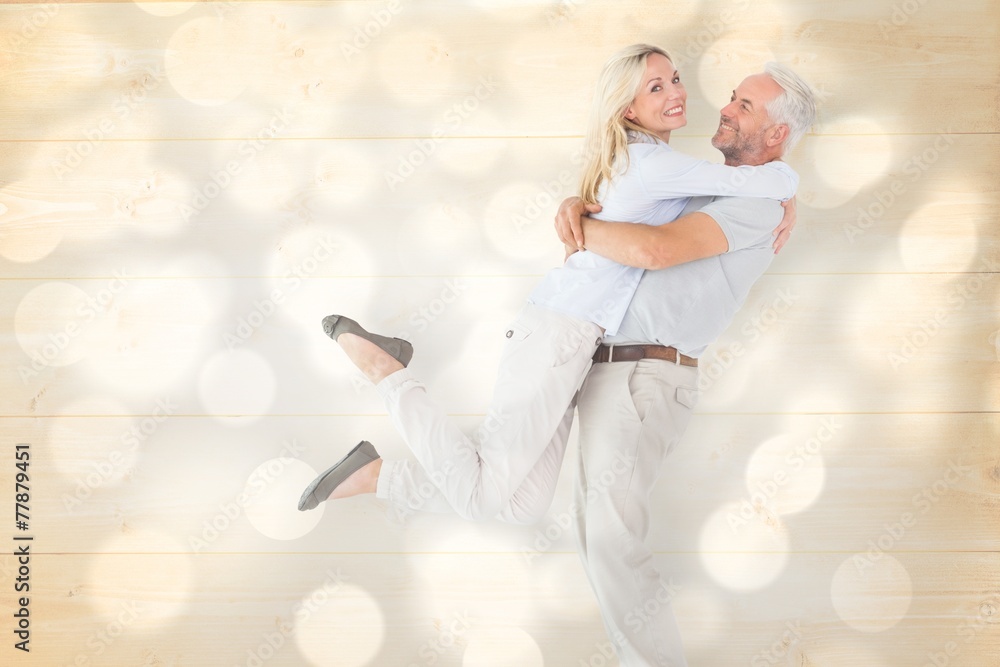 Poster Composite image of man picking up his partner while hugging here