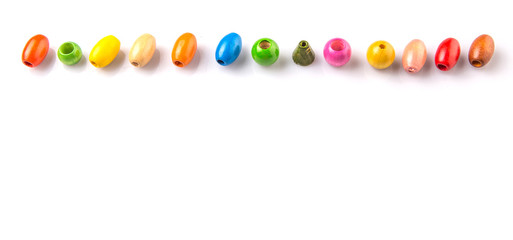 Colorful wooden beads on white background - 77879459