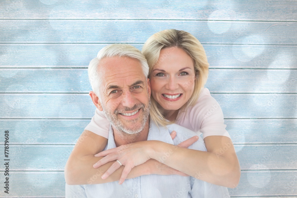 Poster smiling couple embracing and looking at camera