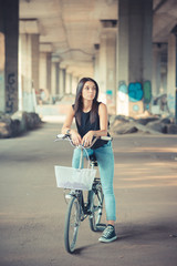 Obraz na płótnie Canvas young beautiful brunette straight hair woman using bike